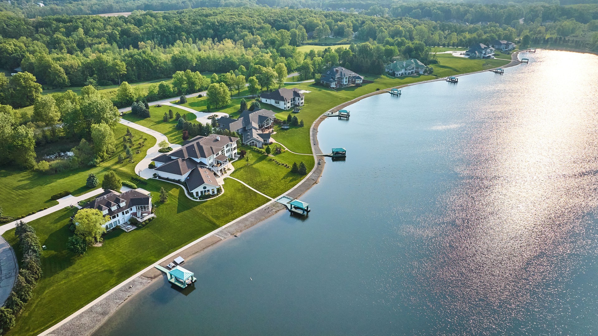Lakeside property aerial large homes with docks in water mansions